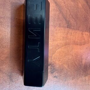 Fenty Beauty Refillable Lipstick Case with Red lipstick